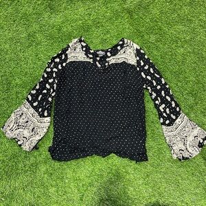 Ladies black and cream paisley and polka dot top with bell sleeves.